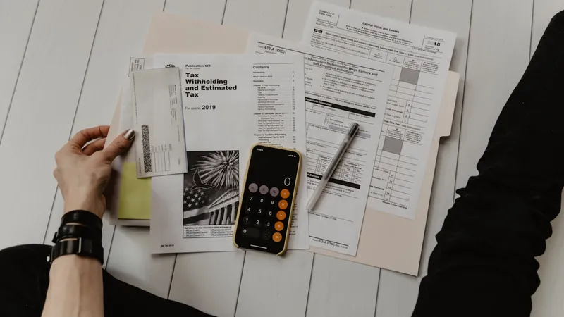 Open ledger with handwritten figures and a fountain pen on a wooden desk